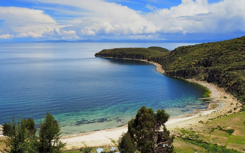 Clear waters on Isla del Sol, Copacabana, Bolivia from a high vantage point that highlights the beauty of the island and tranquility of the lake