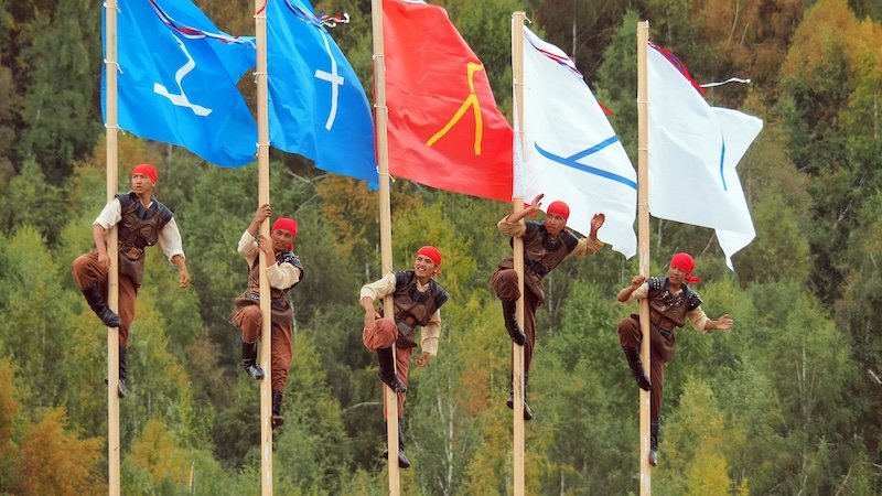 Climbing flag poles and flags at the World Nomad Games in Kyrgyzstan 