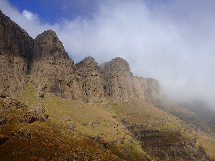 Clouds rolling over the Drakensberg Mountain Range in South Africa creating an imposing yet moody scene that dared us hikers