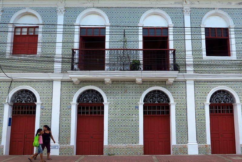Colonial architecture in Iquitos, Peru featuring properties with beautiful archways and doors