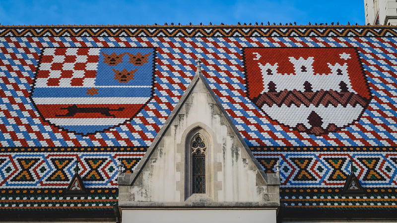 Colourful roof on St. Mark's Church in Zagreb featuring castle designs and nationalistic colors and designs for a unique pattern in Croatia