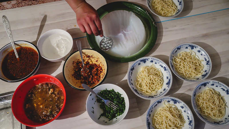 Cooking class ingredients in Karakol, Kyrgyzstan preparing to make the classic dish Ashlyan-Fu with noodles, spices and seasoning 