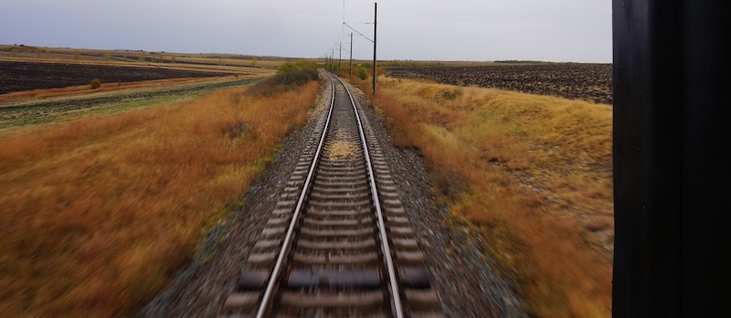 Countryside views in Europe with train tracks as the focal point 
