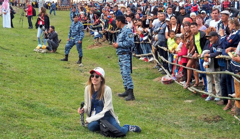 Crowds watching the World Nomad Games in Kyrgyzstan with That Backpacker Audrey Bergner enjoying taking photos 