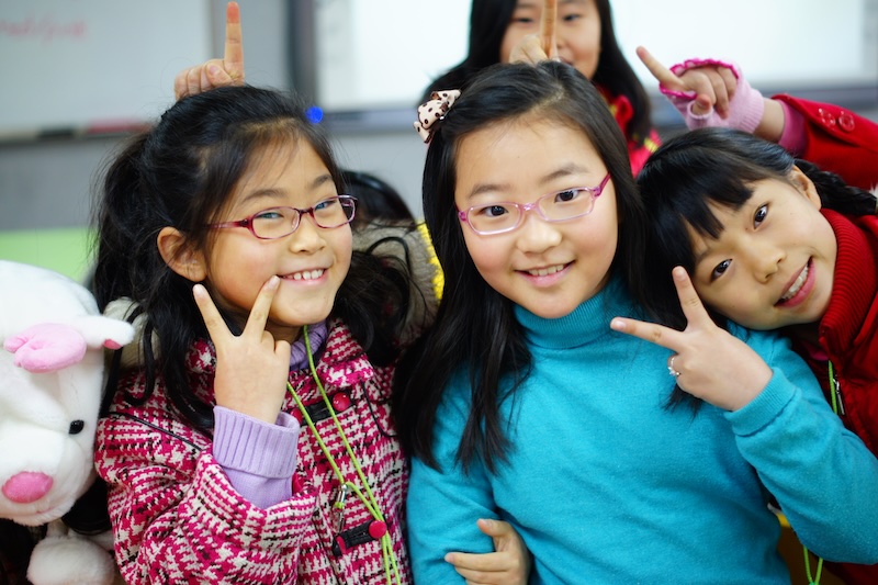 Cute Korean students posing whilst teaching Elementary school classroom in South Korea 