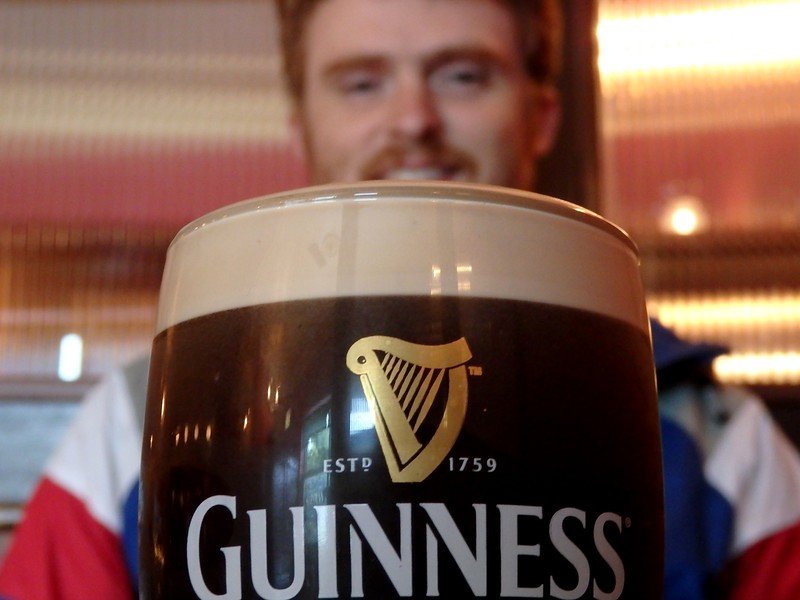 A daily pint of Guinness with foamy head when in Dublin, Ireland with Nomadic Samuel keen to take a sip 