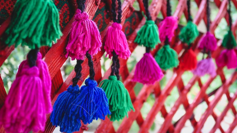 Decorating the interior of a yurt in Kyzyl-Tuu, Kyrgyzstan with colorful pink, green and blue enhancements