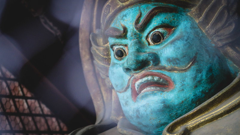 Deities guarding the entrance to the temple on Mount Takao with an imposing appearance and piercing eyes in Japan