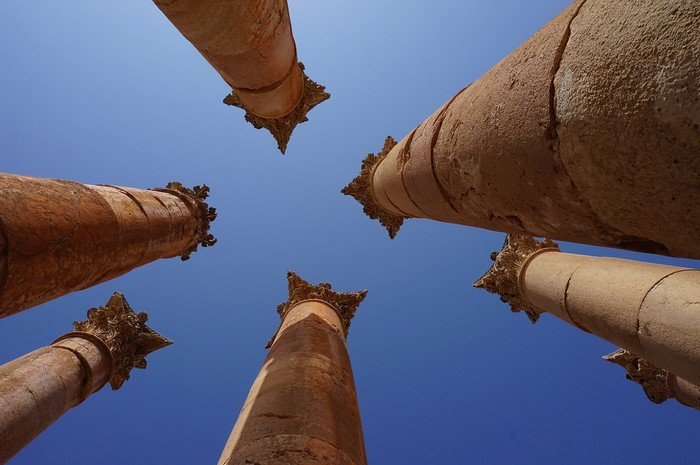 Destinations in Jordan To Visit: There's More Than Just Petra! Temple ruins in Jerash, Jordan from a low vantage point looking upwards!