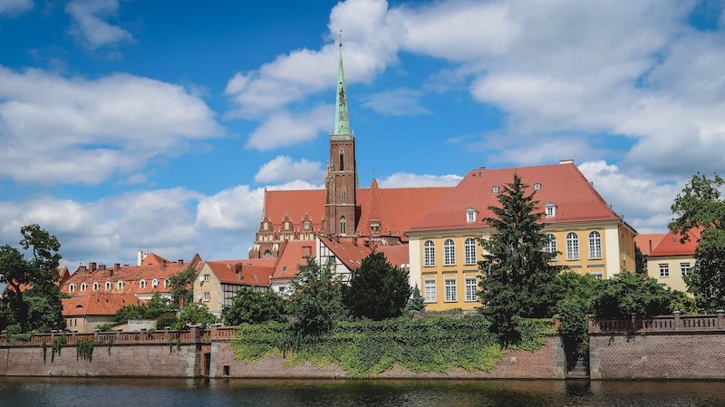 Distinct architecture in Wroclaw, Poland with cathedral overlooking the waterway 