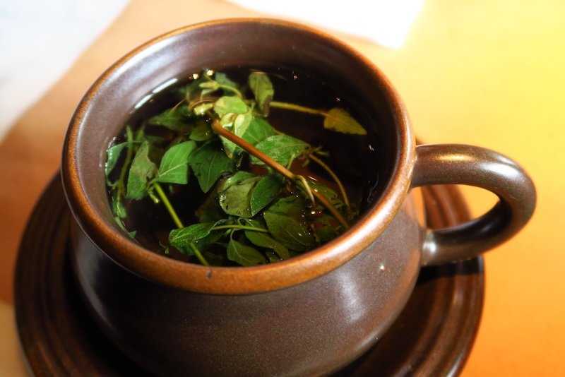 Drinking cocoa special tea in Cusco, Peru to prepare for altitude gain going on Inca Trail hike 