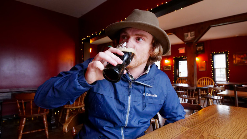 Drinking craft beer at The Groundswell Inn in Isle Madame, Cape Breton is a happy Nomadic Samuel