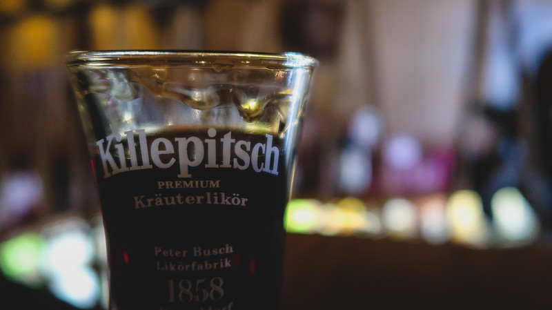 Drinking Killepitsch, a popular liqueur in Düsseldorf with herbs, fruits, berries and spices galore in Germany 