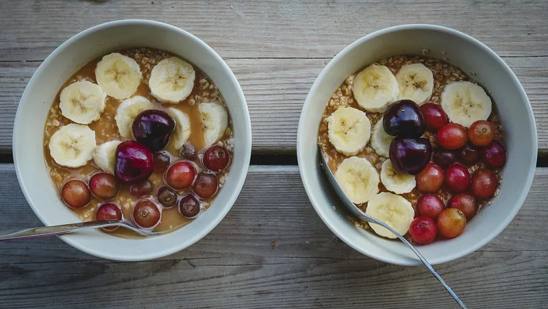 Easy camp breakfast of maple syrup oatmeal with banana, grapes and cherries at our off-grid cabin stay in Ontario Easy camp breakfast of maple syrup oatmeal with banana, grapes and cherries at our off-grid cabin stay in Ontario