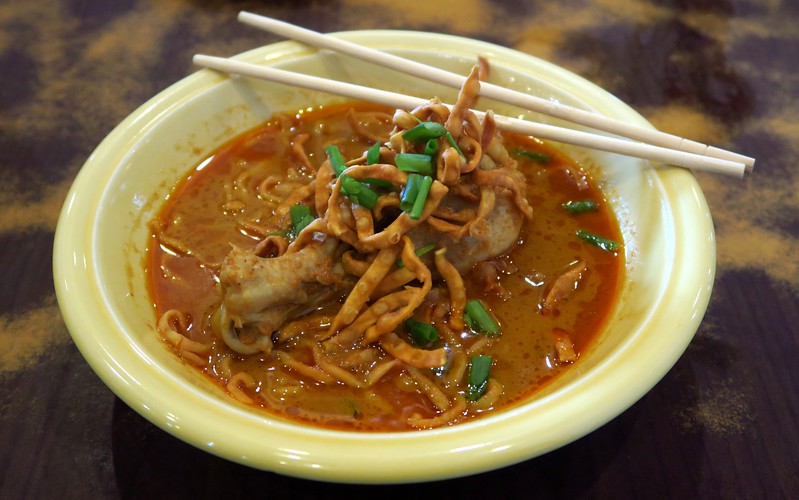 Eating a bowl of khao soi the local specialty dish in Chiang Mai