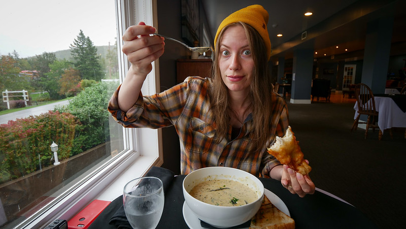Eating a creamy chowder at Mac Rae's Dining Room in Dundee with That Backpacker Audrey Bergner holding up a delicious spoonful 