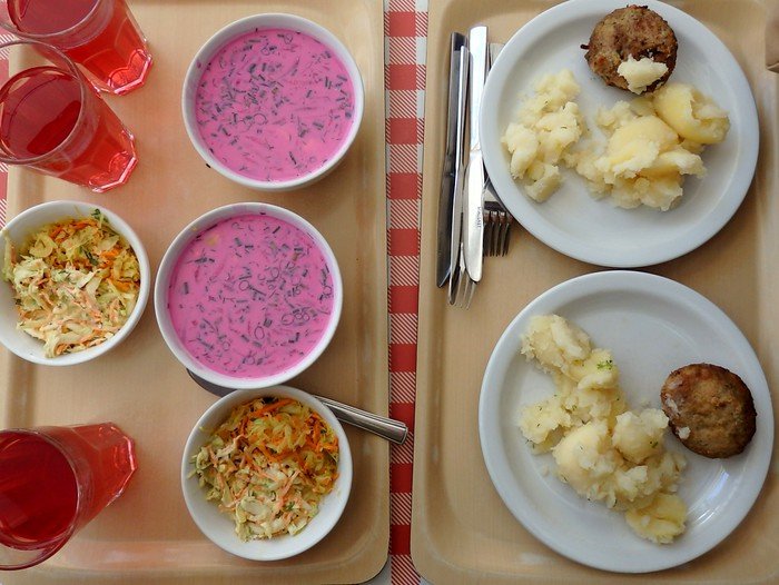 Eating at a Polish Milk Bar in Warsaw, Poland with colorful beetroot soup, hearty potato dishes with meat and salad along with drinks on offer