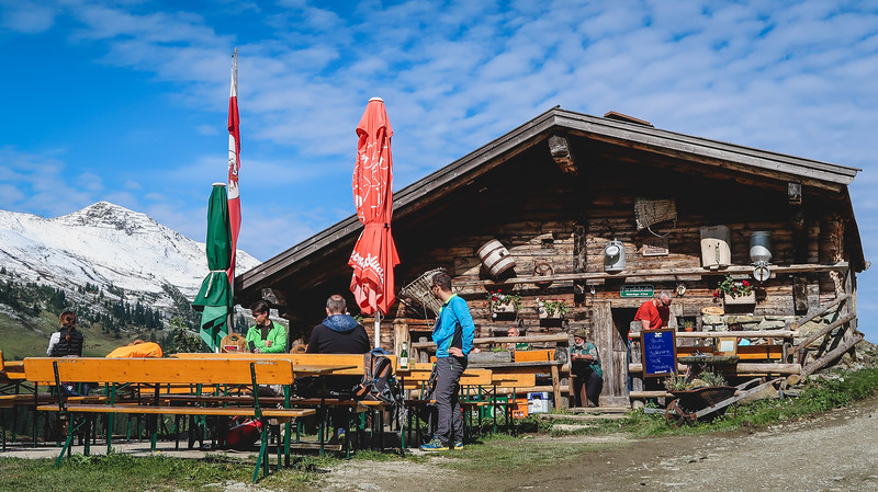 Eating at Farmkehr Alm a restaurant in the mountains in Tyrol with an outdoor seating area featuring plenty of rustic charm in Austria 