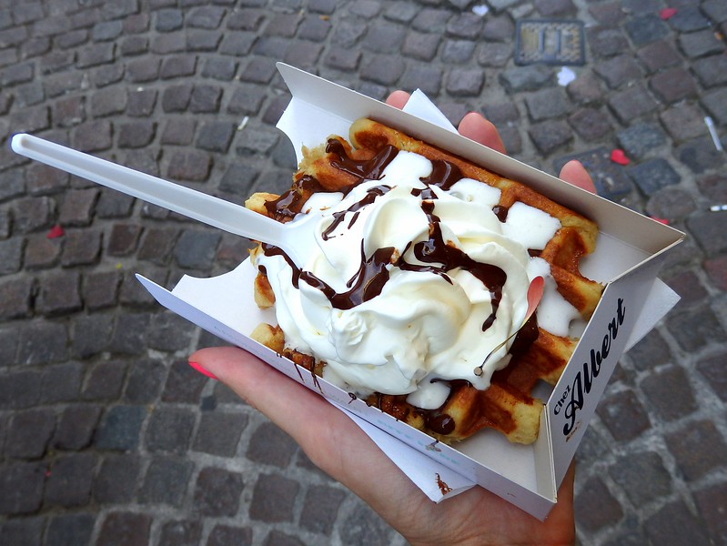 Eating Belgian waffles topped with copious amounts of whipped cream and chocolate is one of those things to do in Bruges! Eating Belgian waffles topped with copious amounts of whipped cream and chocolate is one of those things to do in Bruges!