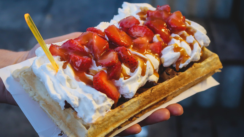 Eating gofry style waffles in Gdynia as decadent sweet treat and tasty street food snack in Poland 