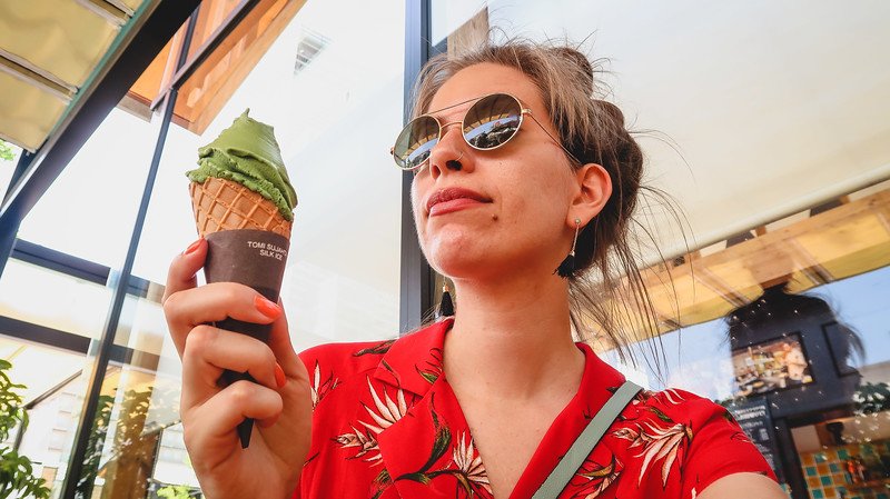 Eating matcha ice cream in Osaka is a stylish That Backpacker Audrey Bergner indulging her sweet tooth in Japan on a hot day