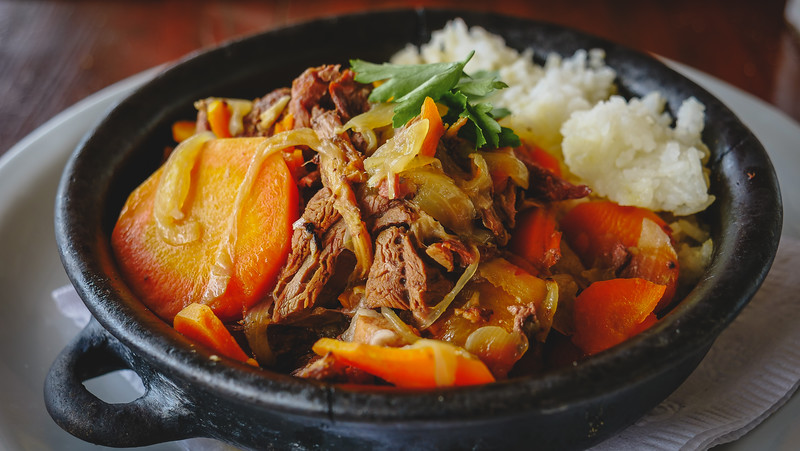 Eating Patagonian Lamb Stew at the estancia for lunch with mixed vegetables and rice as our hearty Patagonian meal in Peninsula Valdes, Argentina