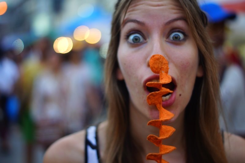 Eating tornado chips at the night market in Chiang Mai, Thailand is a must try street food item as devoured by That Backpacker Audrey Bergner