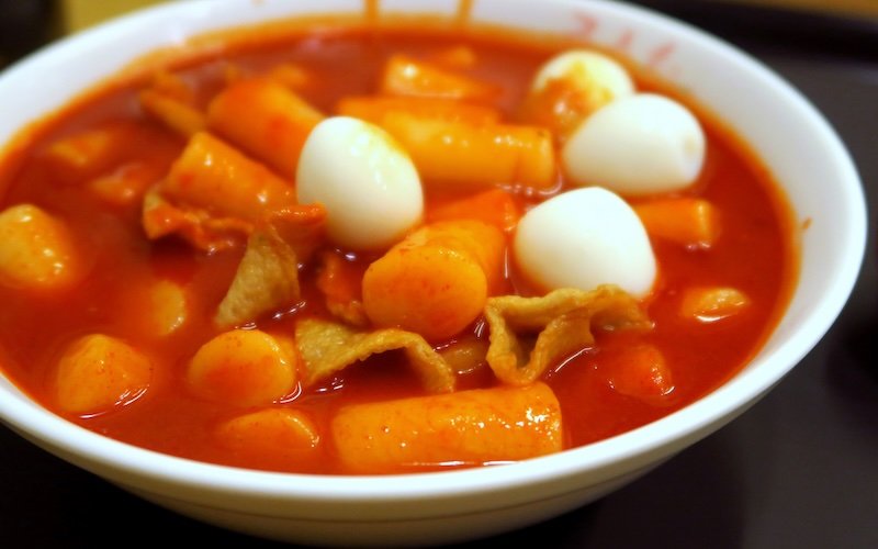 Eating tteokbokki as a must try Korean dish on our bucket list in Seoul, Korea 