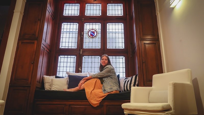Enjoying a beautiful apartment airbnb in Buenos Aires with its high ceilings in Argentina with That Backpacker Audrey Bergner all cozy and posing 