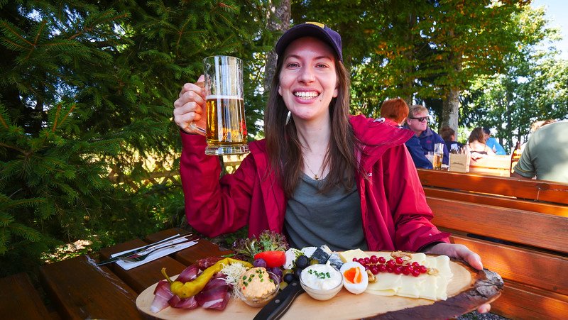 Enjoying Austrian beer atop a mountain is a smiling That Backpacker Audrey Bergner after hiking in Gaisberg, Austria 