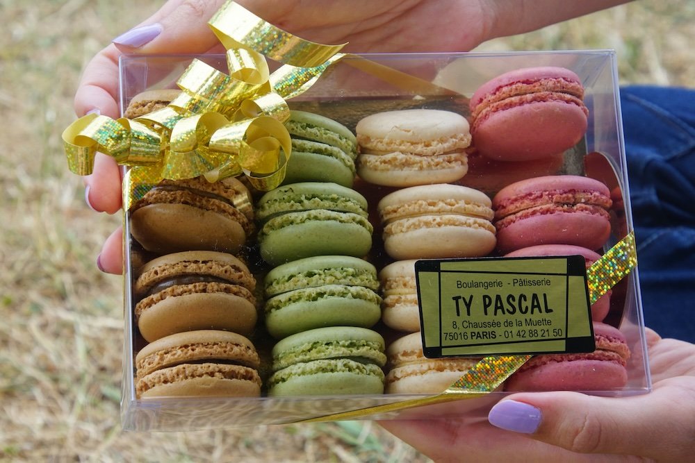 Enjoying colorful macarons for our picnic in Paris, France Enjoying colorful macarons for our picnic in Paris, France