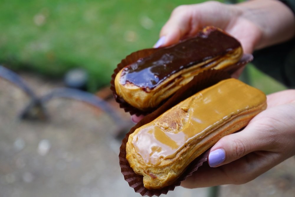 Enjoying Paris street food and baked goods in France at a park Enjoying Paris street food and baked goods in France at a park