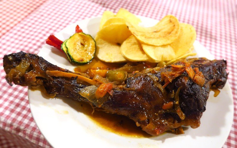 Enjoying traditional food in Costa Brava, Spain with a giant piece of meat and well done potatoes 