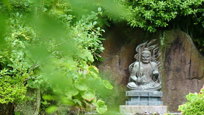 Entrance to the cave at Hasedera in Kamakura as framed by foliage in Japan Entrance to the cave at Hasedera in Kamakura as framed by foliage in Japan