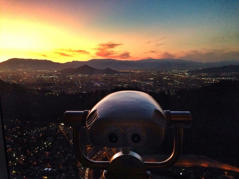 Epic viewpoint of Santiago during sunset in Chile with skyline bright lights and spectacular mountain views 
