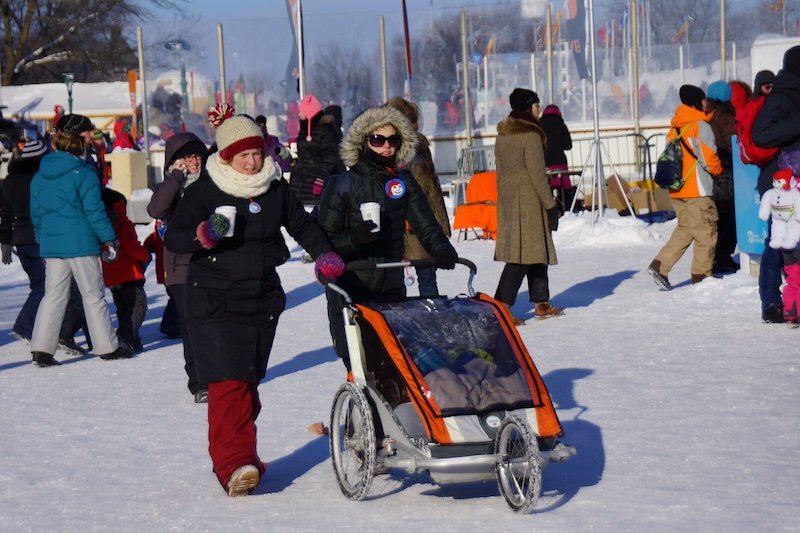 Families embracing the snow and cold in Quebec City Carnaval Families embracing the snow and cold in Quebec City Carnaval