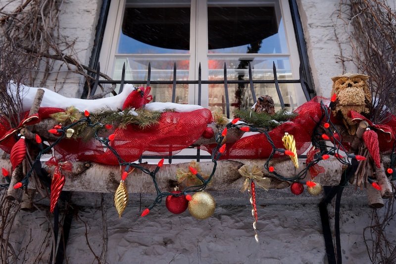 Festive decorations hanging outside of the window in Quebec City in winter Festive decorations hanging outside of the window in Quebec City in winter