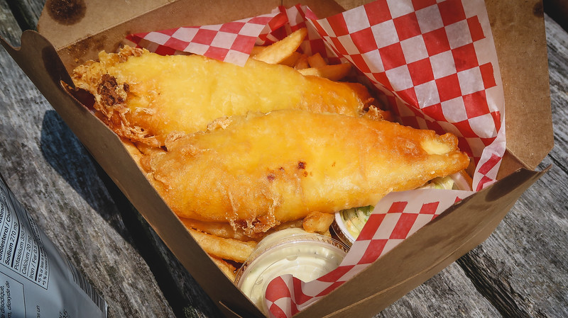 Fish and chips in a box from Alma that we enjoyed in Fundy National Park with tartar sauce in New Brunswick 