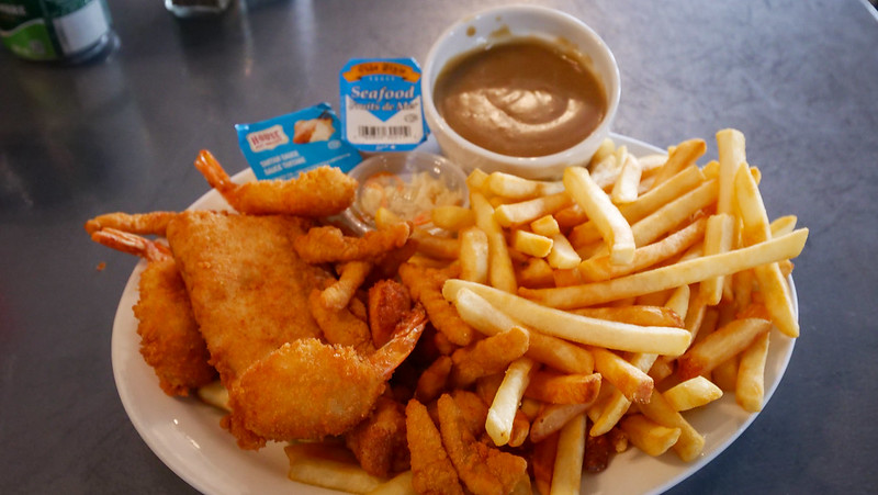 Fisherman Platter at The Island Nest in Arichat, Isle Madame with an assortment of seafood on offer including fries and gravy on Cape Breton, Nova Scotia 