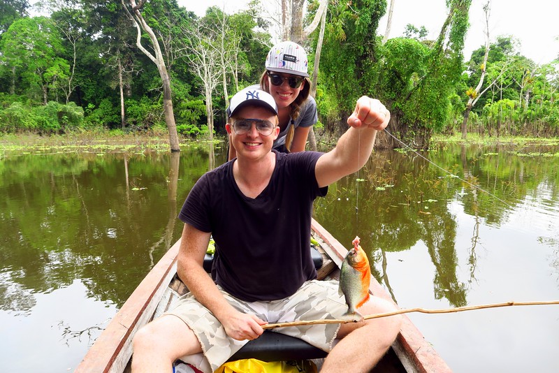 Fishing for piranhas on the Amazon with That Backpacker Audrey Bergner and Nomadic Samuel making the catch of the day 