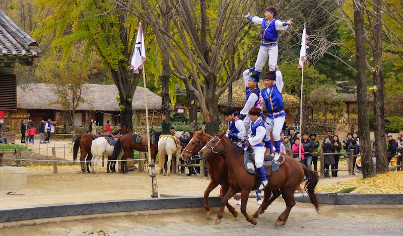 Five Korean performers stacked on two horses at the Korean Folk Village in Yongin, South Korea 