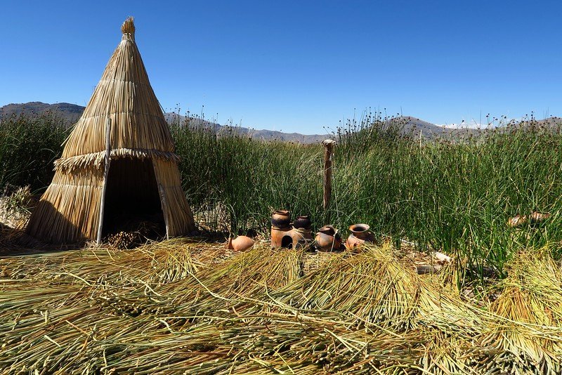 Floating islands of Uros with huts and pottery on display in Peru whilst visiting Lake Titicaca 