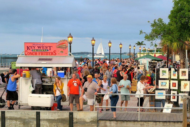 Florida Keys Sunset Celebration on Mallory Square packed with tourists all wearing shorts and t-shirts with street food aplenty on offer