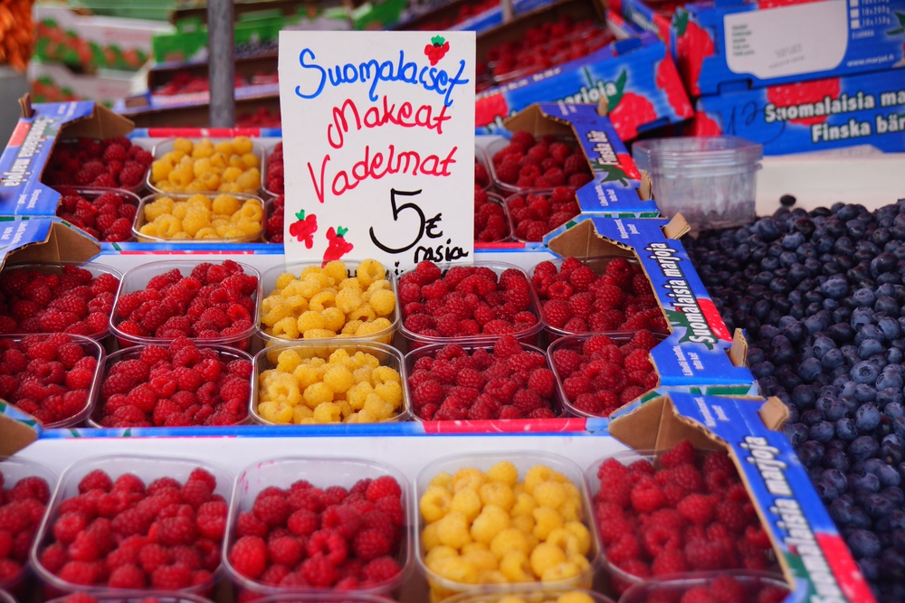 Fresh berries in an assortment of colors for sale at the farmer's market in Finland during the summertime 