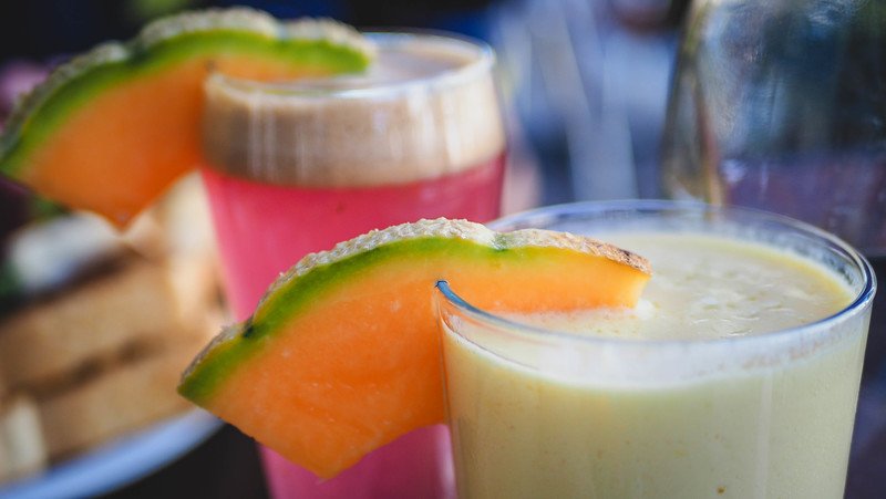 Colorful fresh juices and creamy smoothies garnished with cantaloupe slices at Le Cafetier in Sutton, Quebec — a refreshing stop during our Eastern Townships weekend getaway