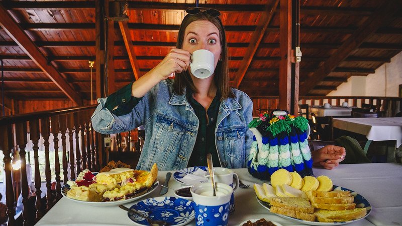 Audrey Bergner of That Backpacker sipping tea in Gaiman, Patagonia, during a Welsh afternoon tea experience surrounded by cakes and pastries. The traditional spread reflects the town’s Welsh heritage, a highlight for visitors on day trips from Puerto Madryn