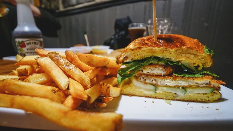 Garlic and herb-crusted haddock on a brioche bun with fries was our comfort food meal in Halifax, NS, Canada 