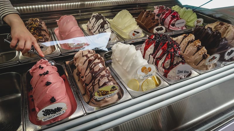 Gelato in Pula scooping local colourful flavours that are mounted 