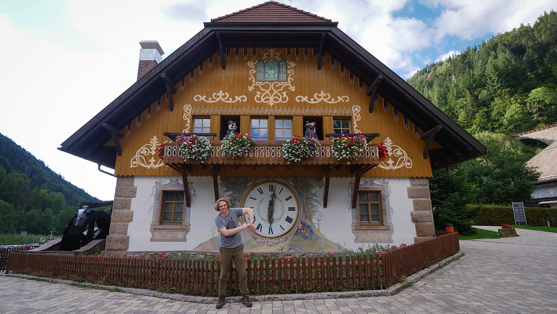 Giant cuckoo clock at Hofgut Sternen in the Black Forest of Germany with Nomadic Samuel telling time with his hand 