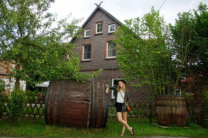 Giant pickle barrels in Germany with That Backpacker Audrey Bergner posing beside them in Spreewald 